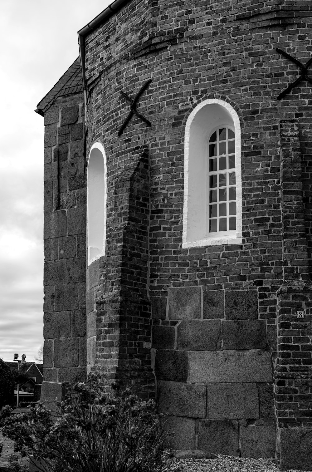 a black and white photo of a brick building