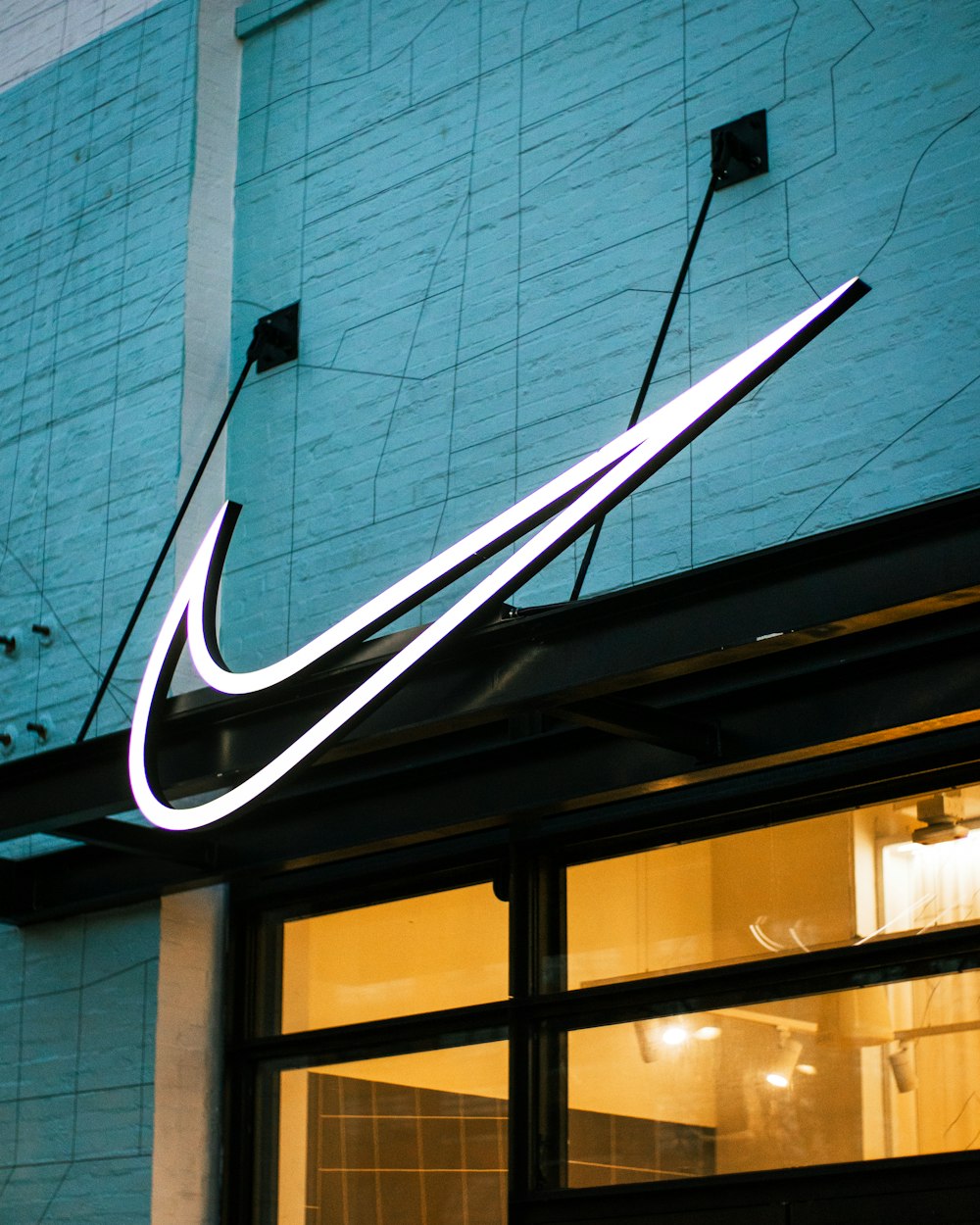 a building with a neon nike sign on the side of it
