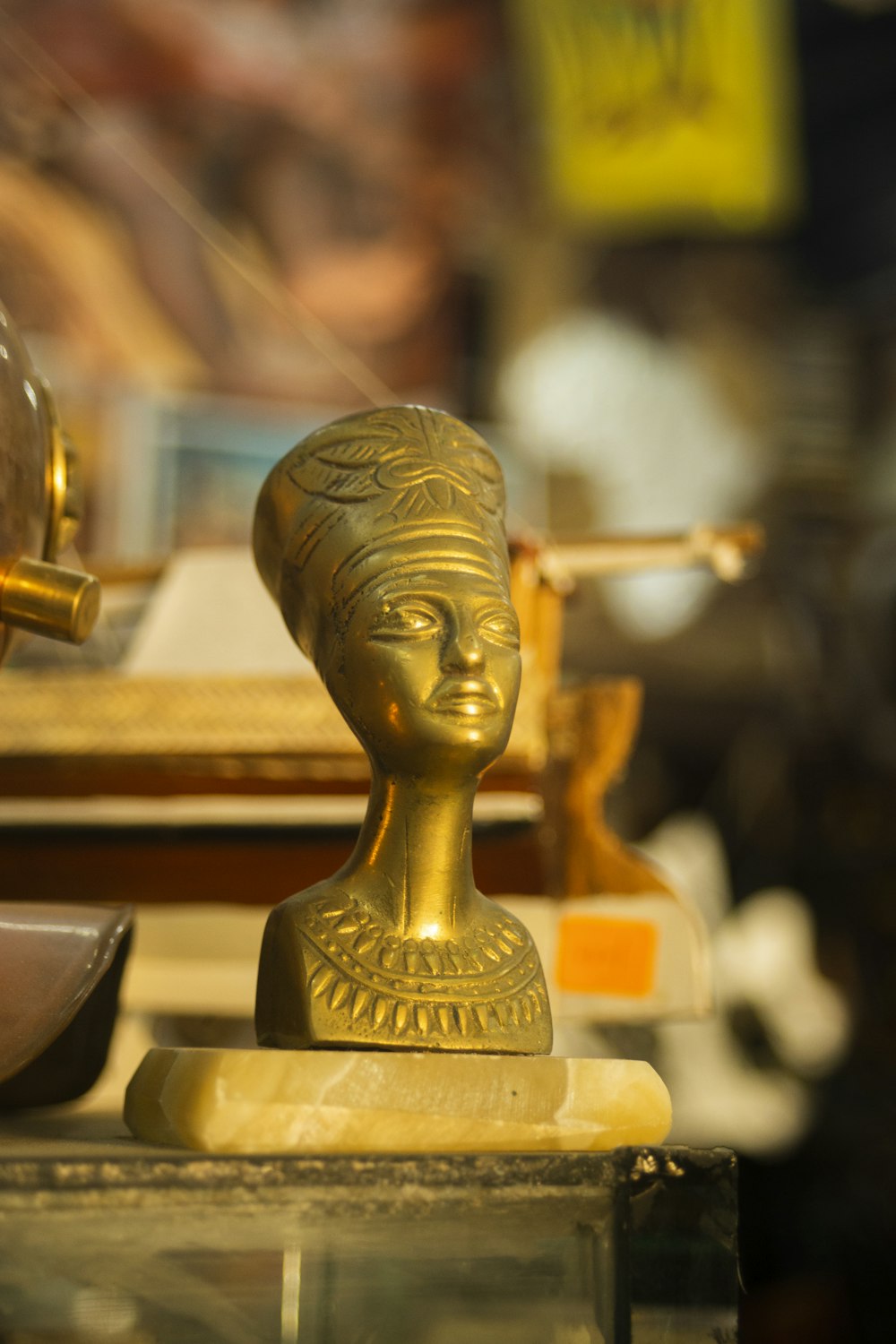 a gold statue of a woman on a table