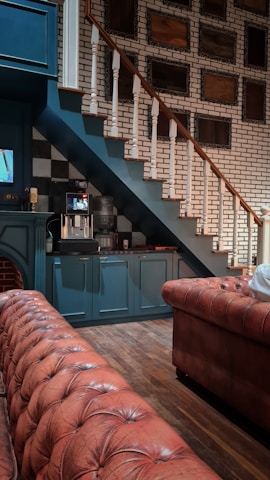 A freshly finished basement featuring cozy seating and stylish flooring.