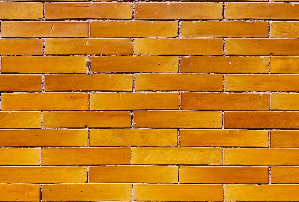 a close up of a yellow brick wall