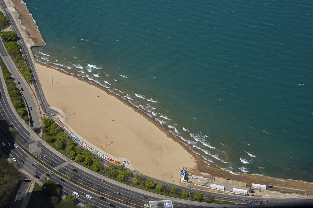 an aerial view of a highway near a beach