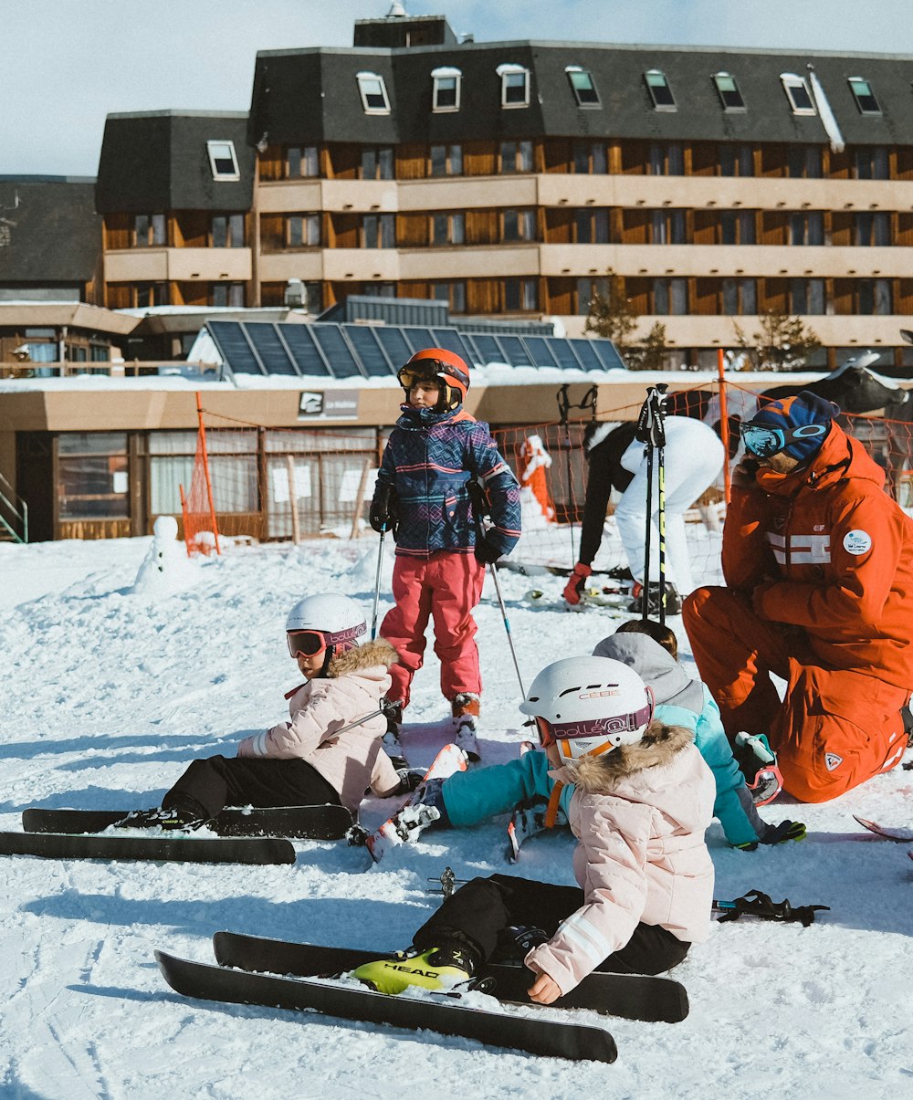 a group of people riding skis on top of a snow covered slope