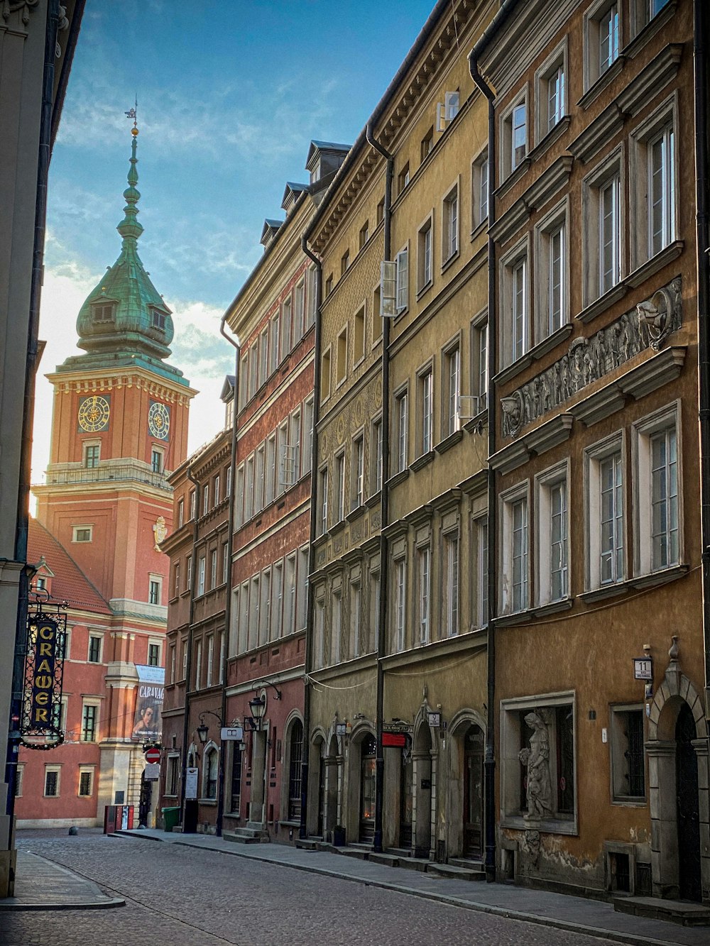 a city street with a clock tower in the background