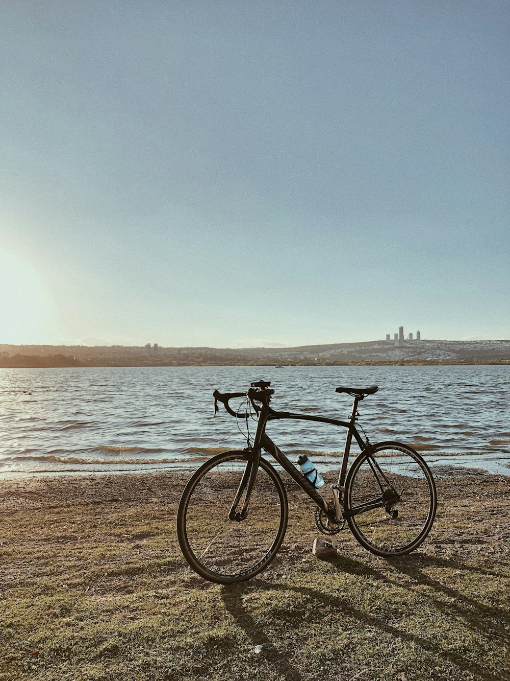 a bicycle is parked next to a body of water