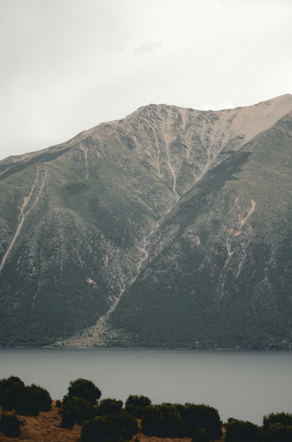 a view of a mountain range with a lake in the foreground