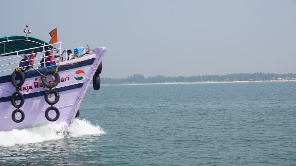 a man riding on the back of a boat in a body of water