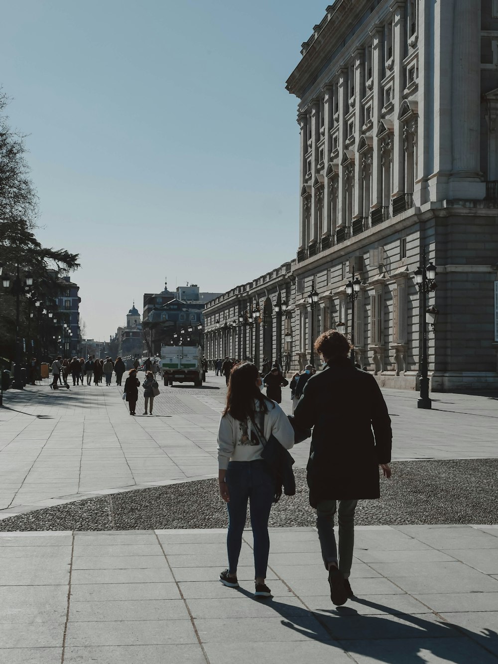 a couple of people walking down a street