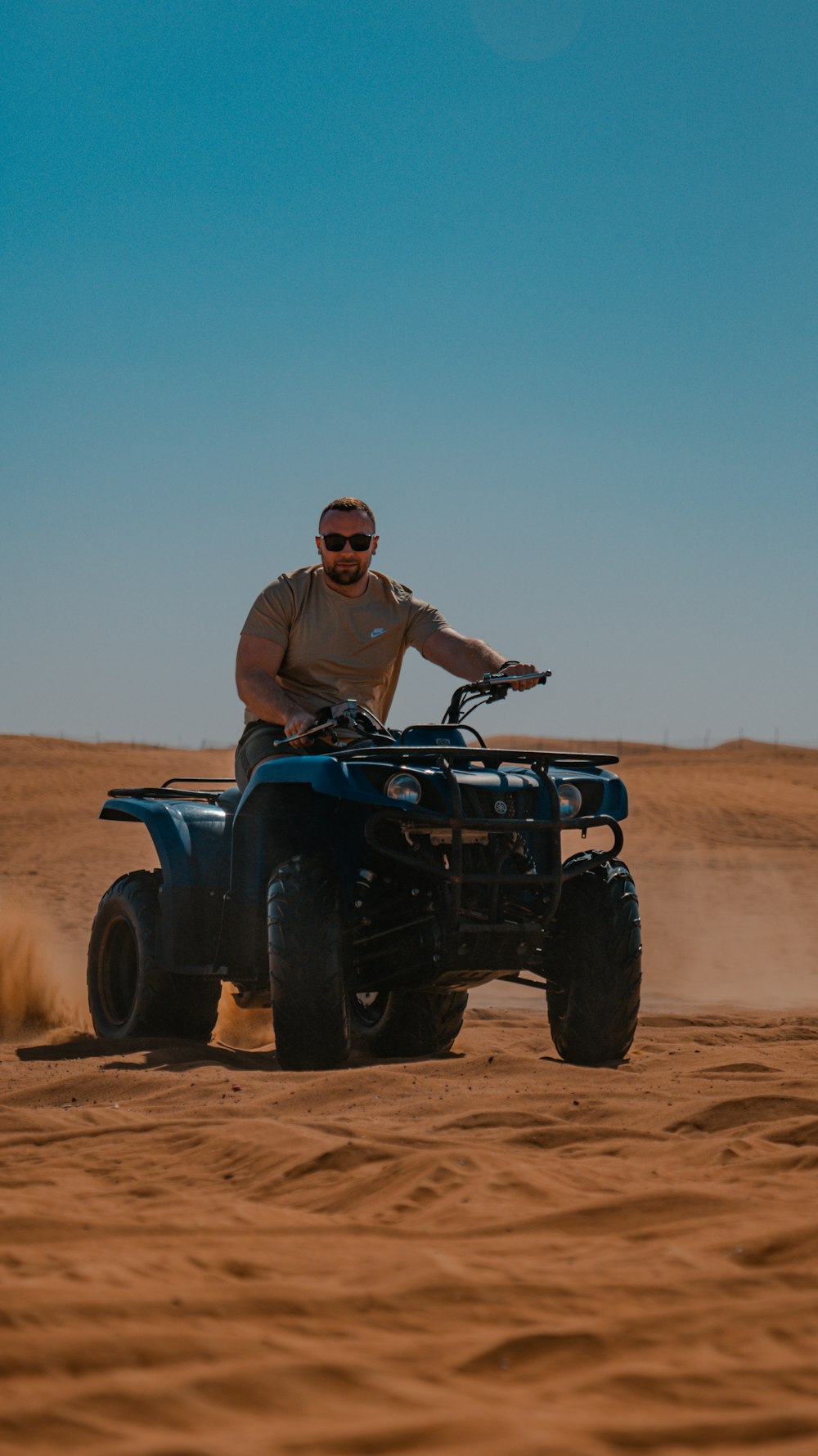 a man riding an atv in the desert