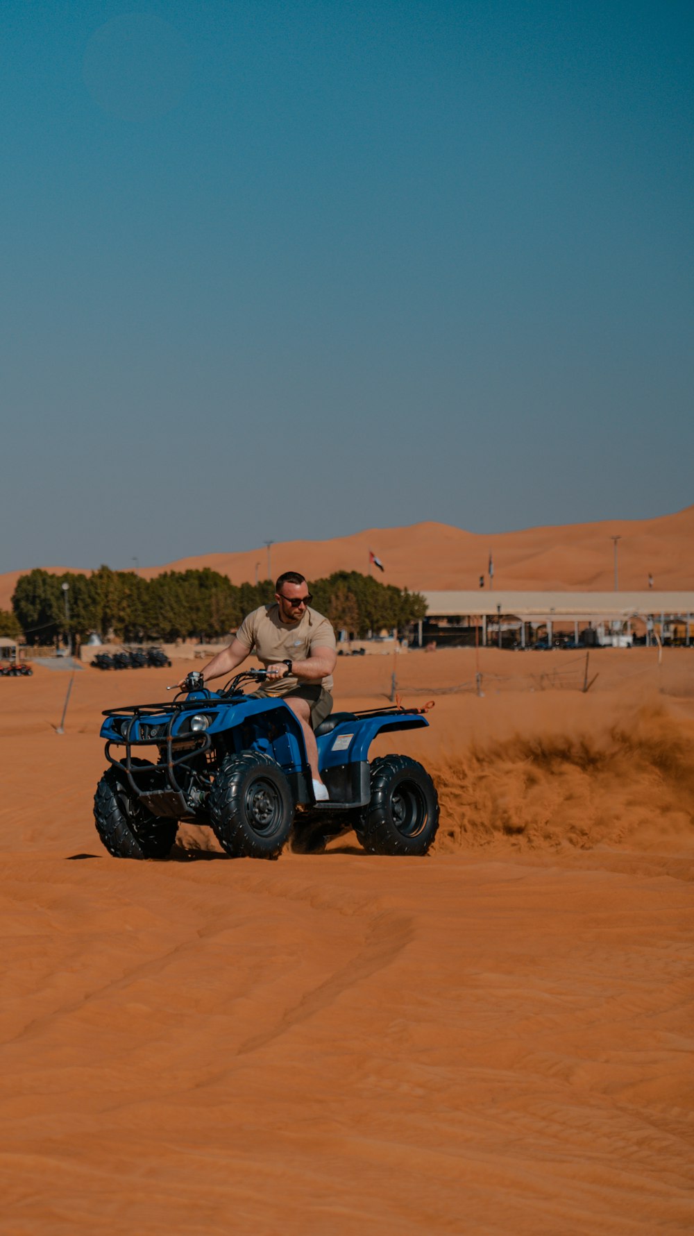 a man riding an atv in the desert