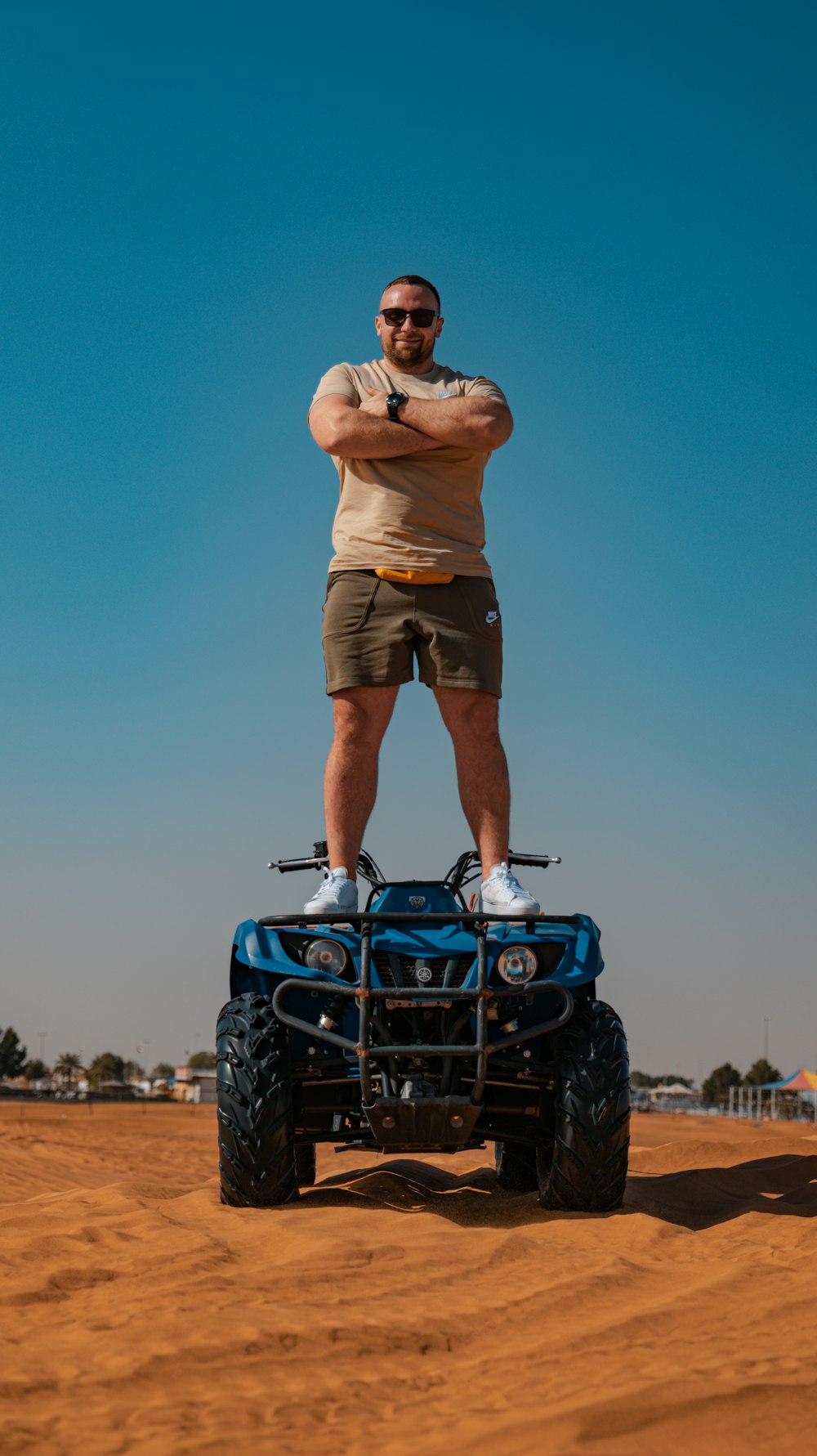 a man standing on top of a four wheeler