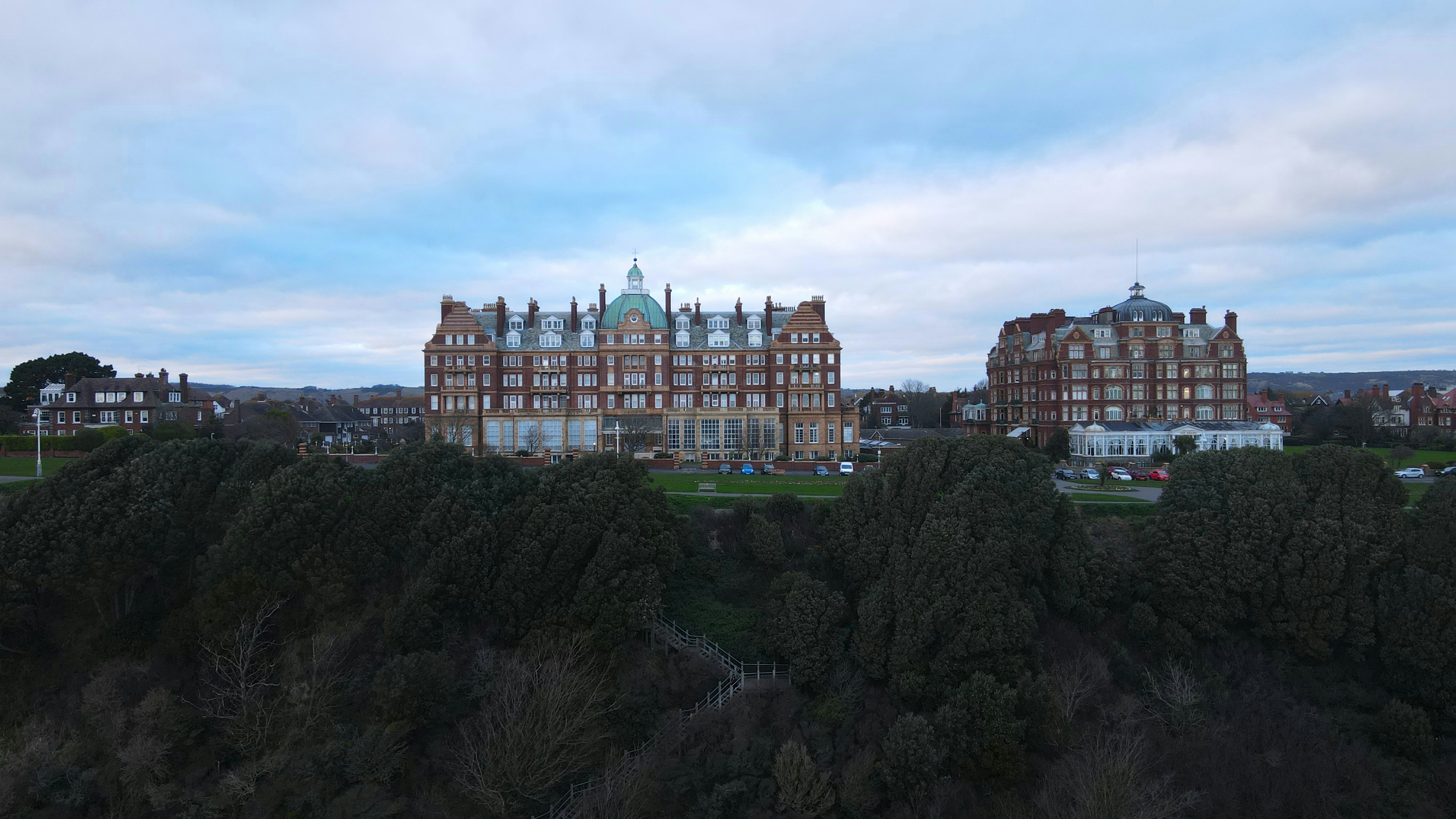 a view of a large building from a hill, 