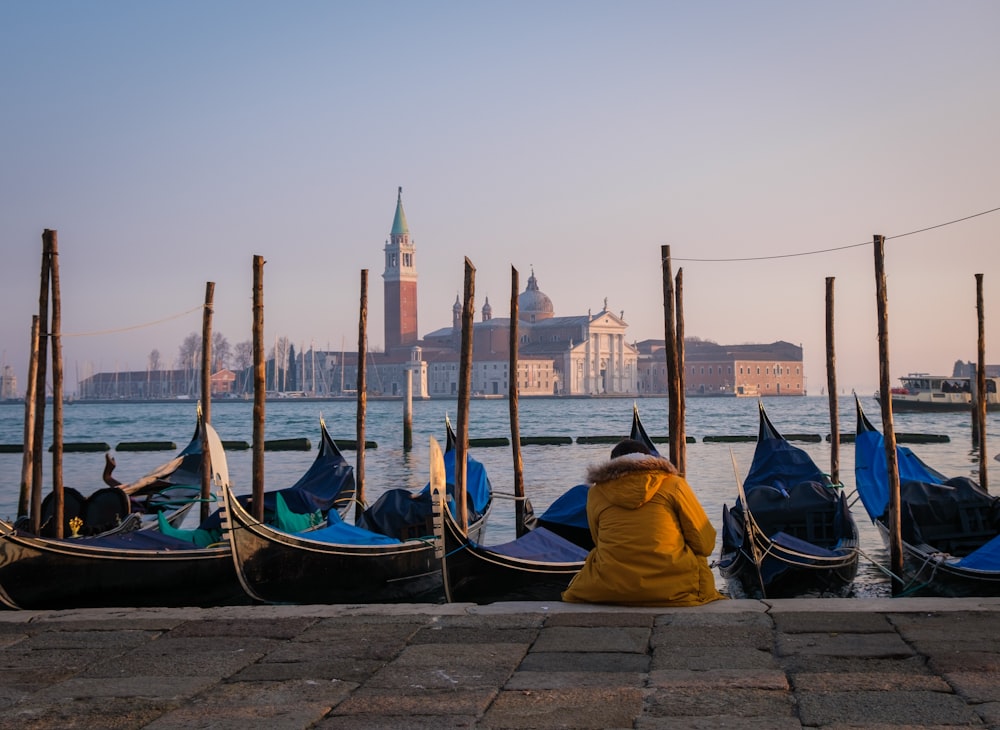 a row of gondolas sitting next to a body of water