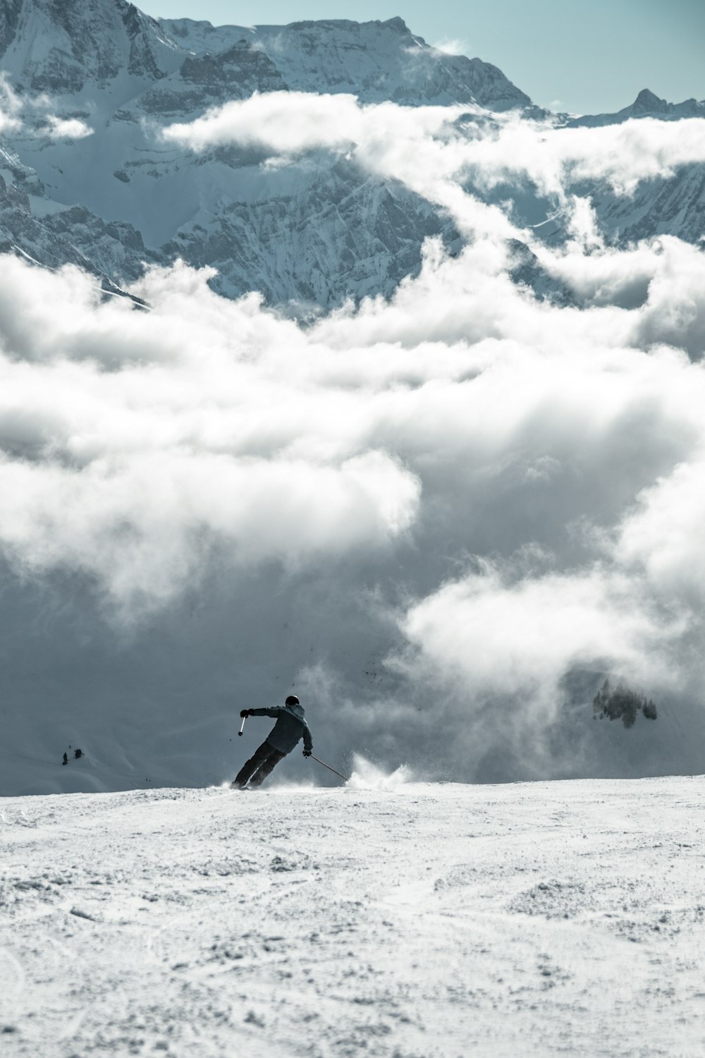 a man riding skis down a snow covered slope