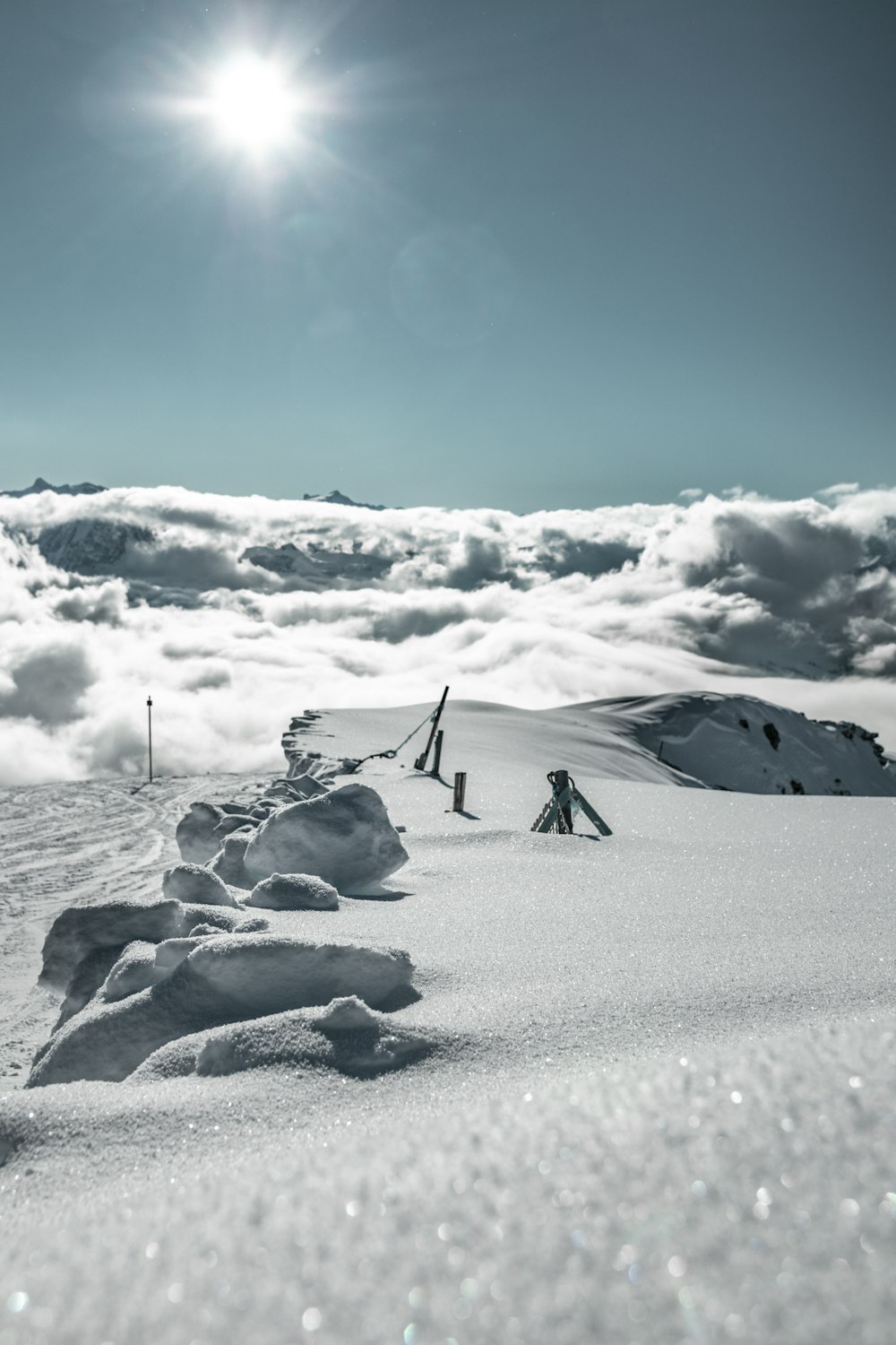 the sun is shining over a snowy mountain