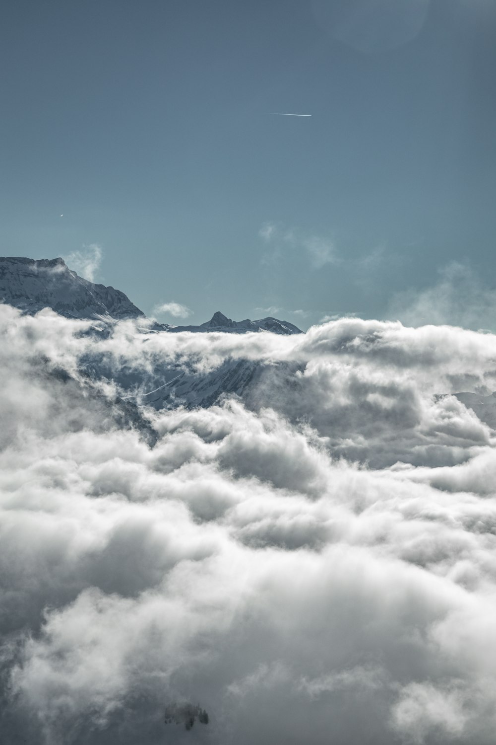 a view of a mountain covered in clouds