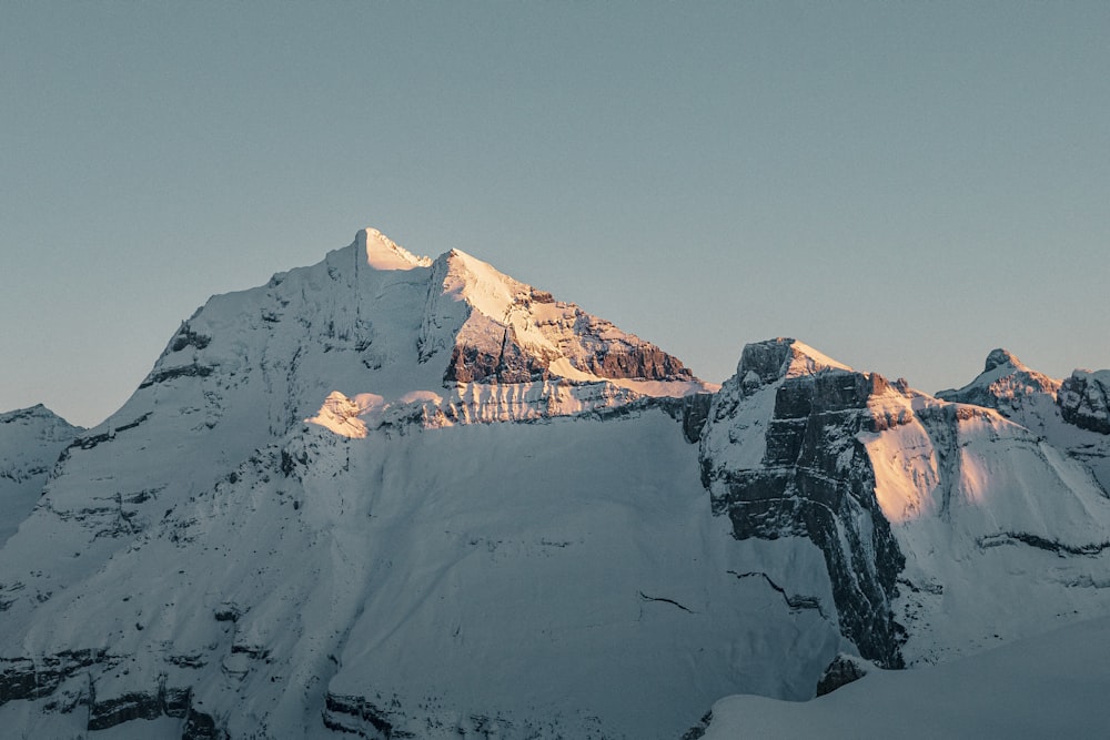 a snow covered mountain with a sky background