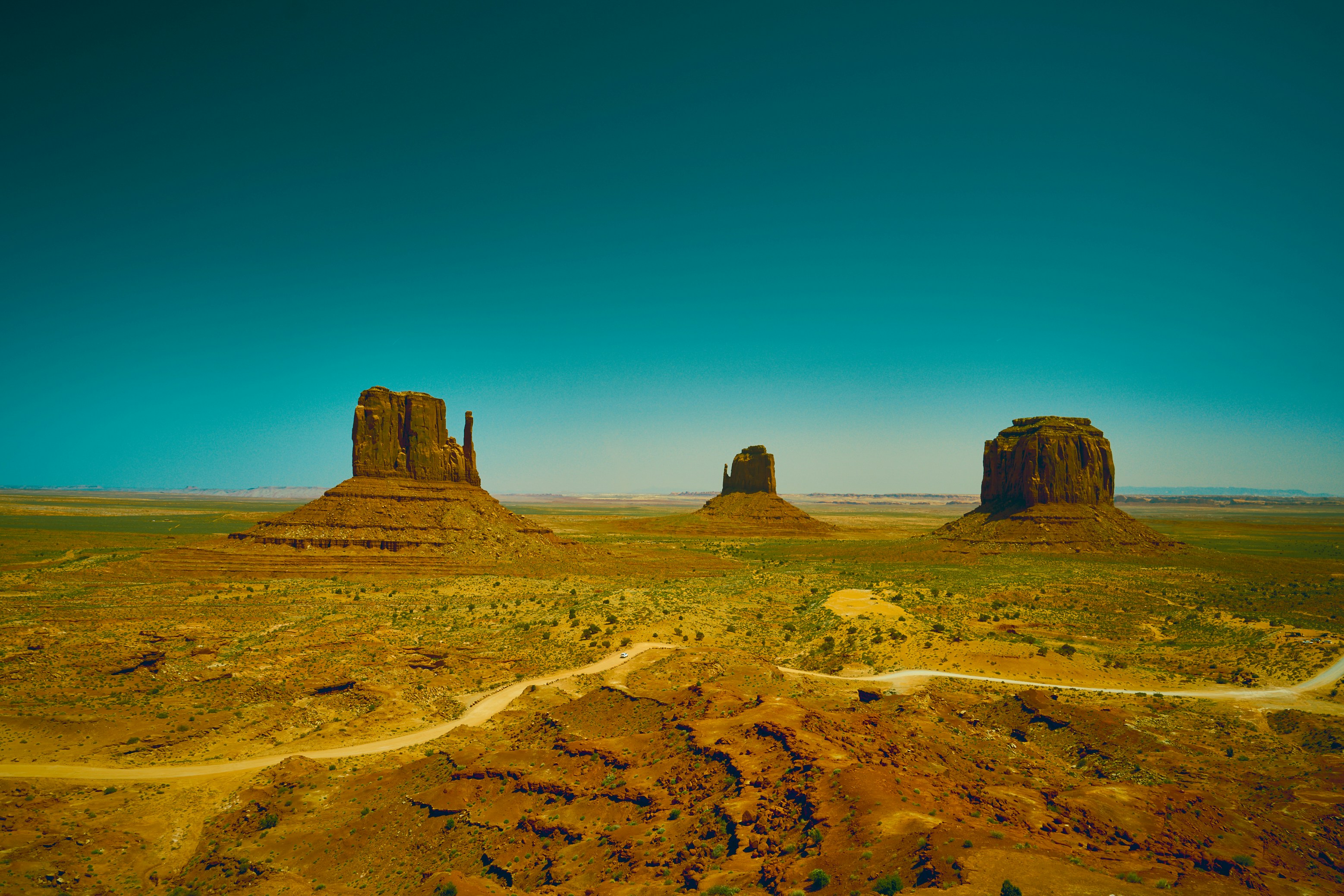 an aerial view of a desert with a road going through it