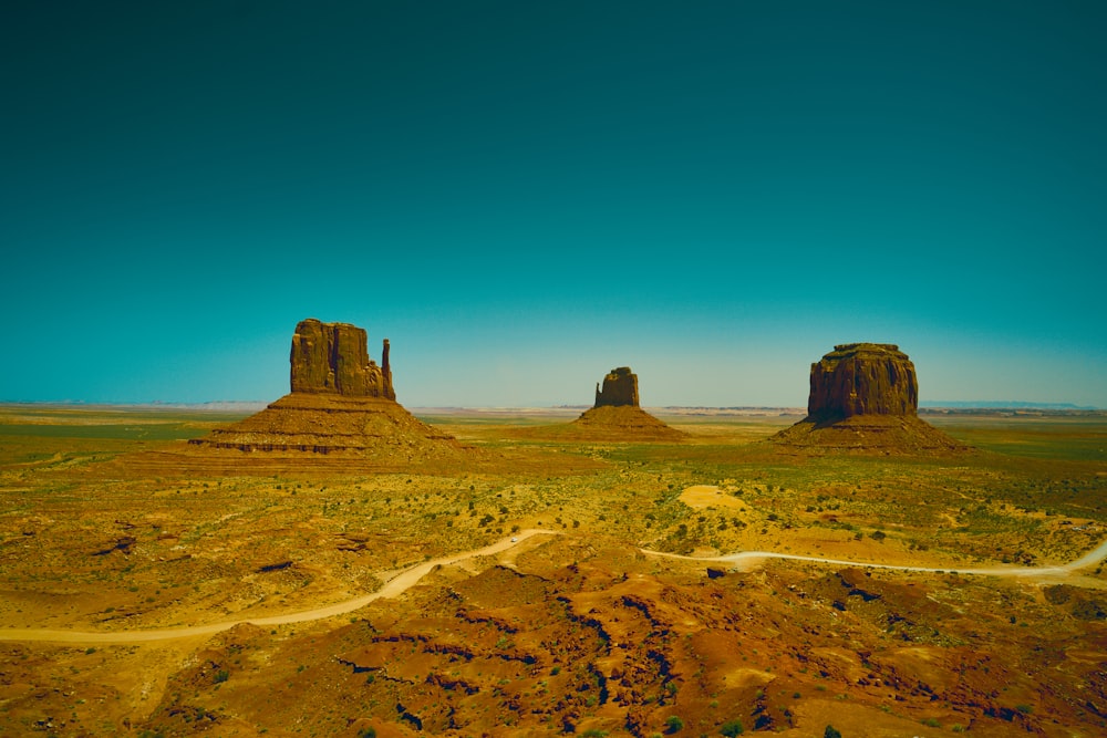 an aerial view of a desert with a road going through it