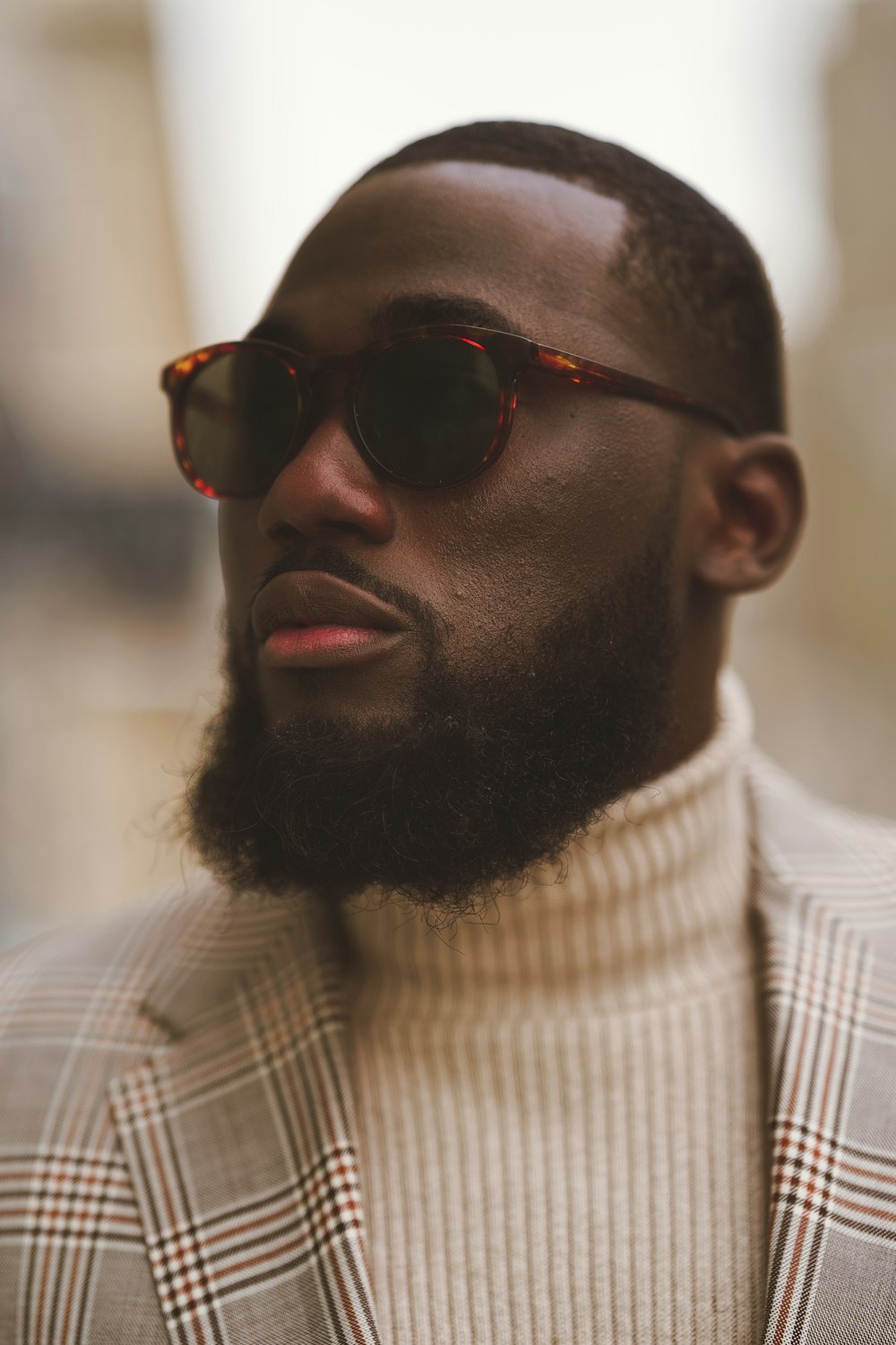 a man with a beard wearing a suit and sunglasses