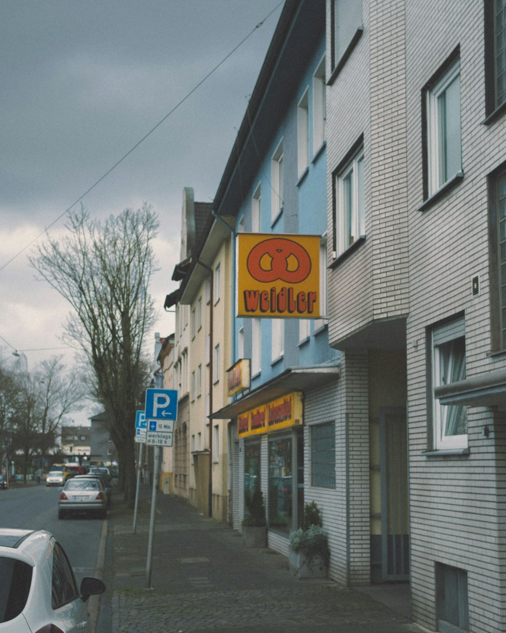 a street corner with cars parked on the side of it