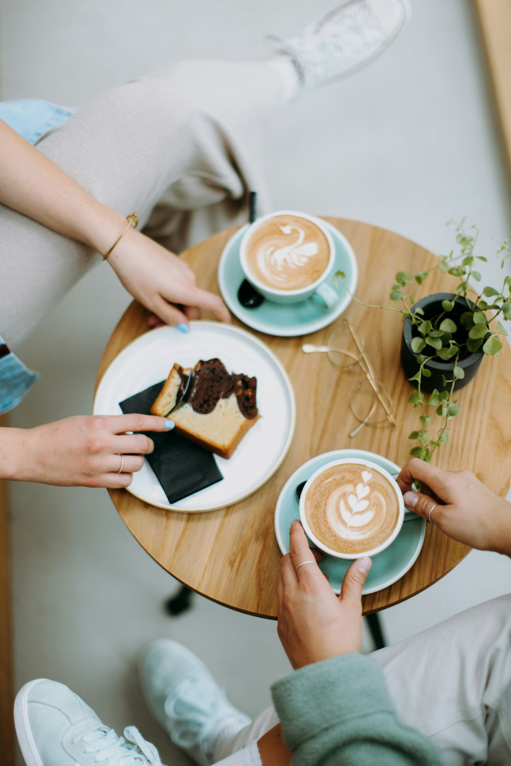 a couple of people sitting at a table with plates of food