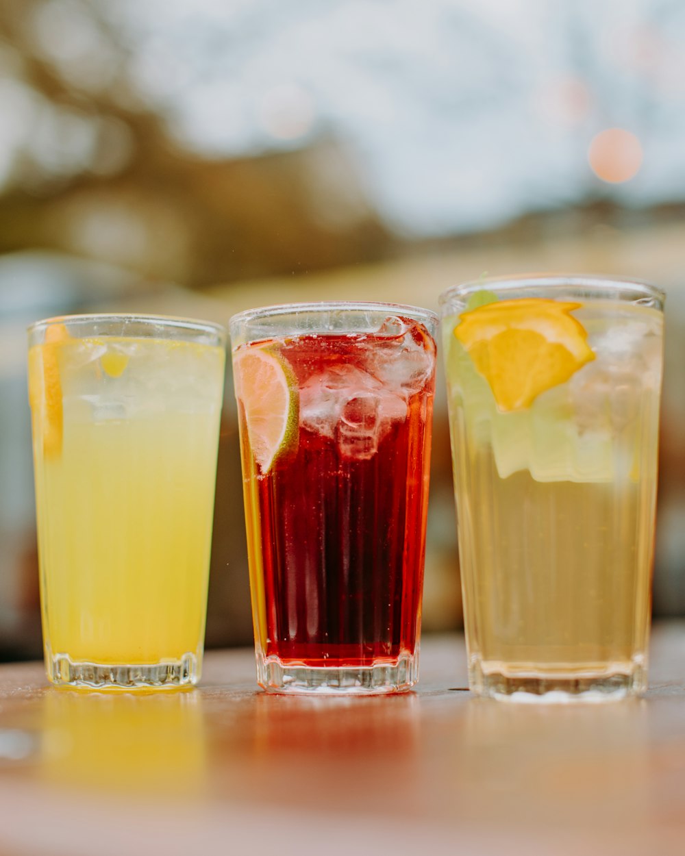 three different types of drinks sitting on a table