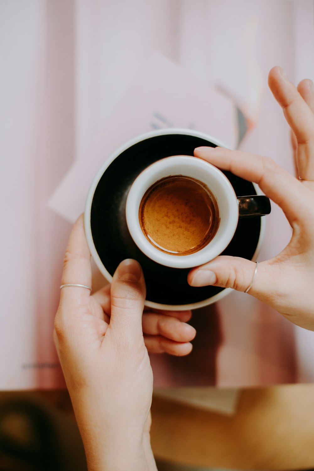 a woman is holding a cup of coffee