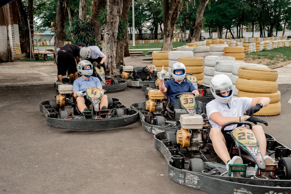 a group of people riding go karts in a park
