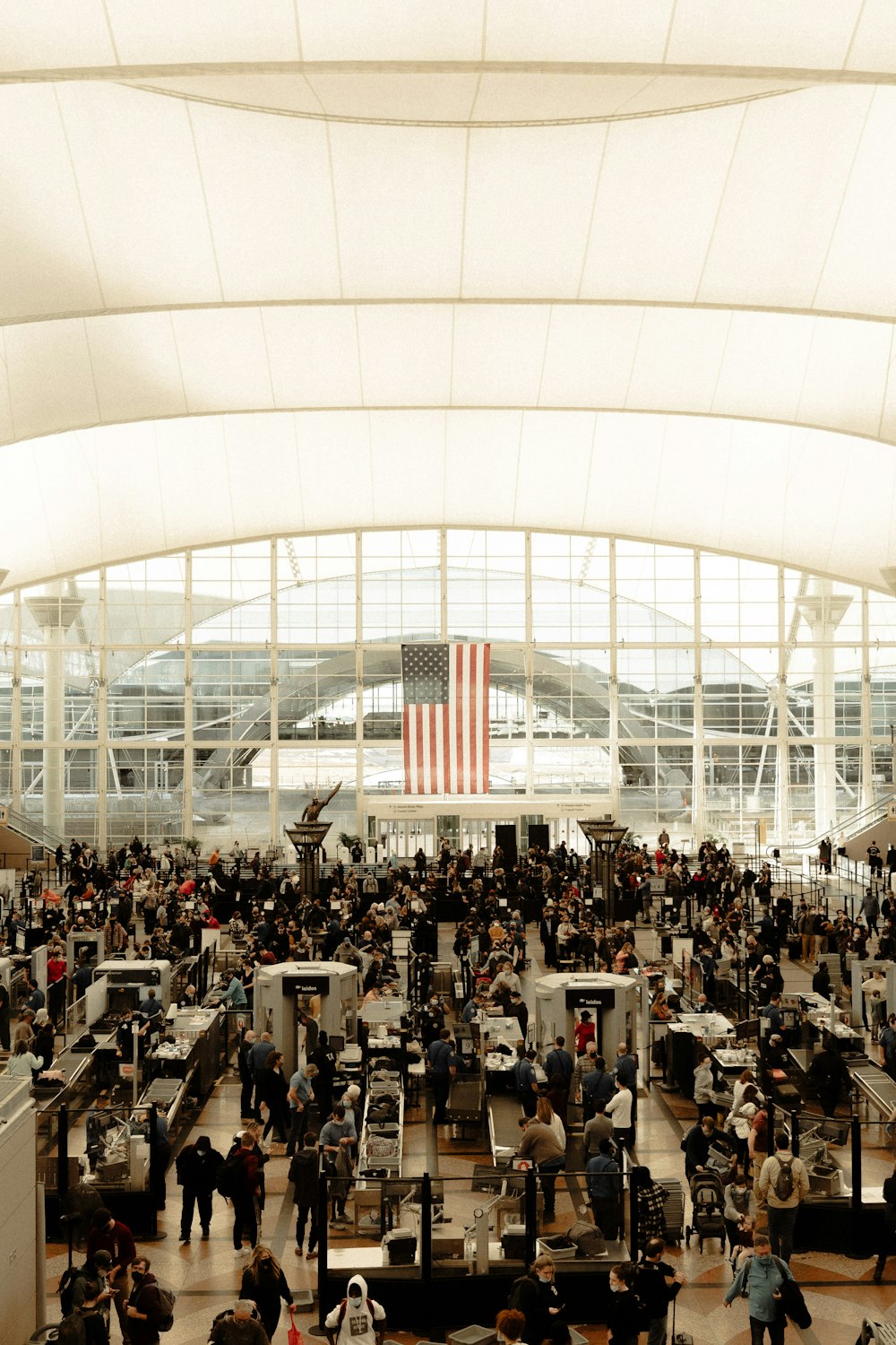 an airport filled with lots of people and luggage