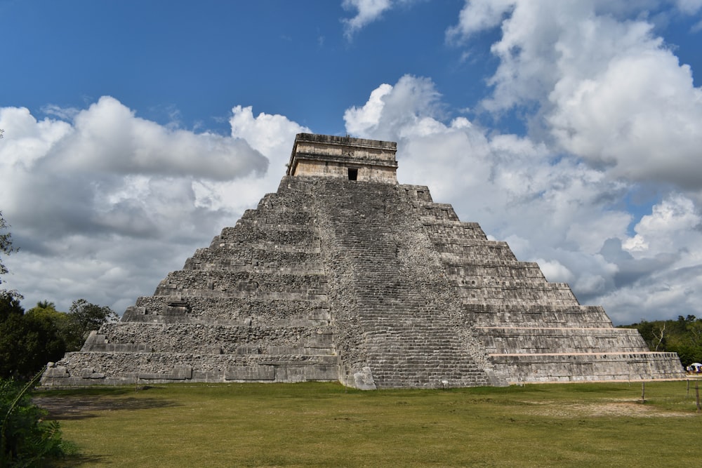 a large pyramid in the middle of a field