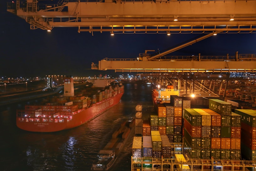 A cargo ship loaded with containers at a bustling port.