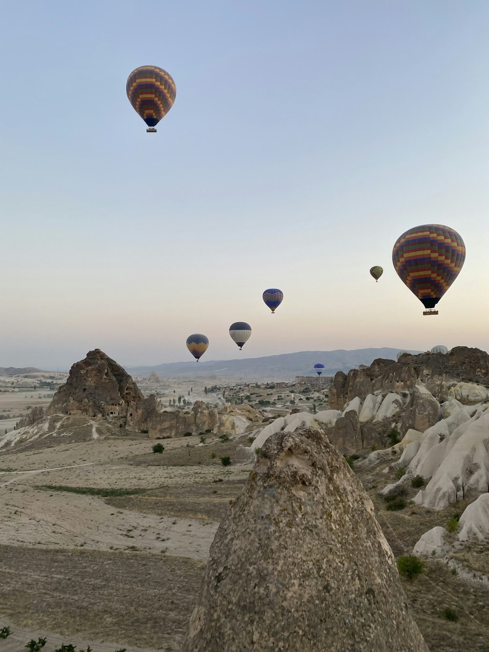 a group of hot air balloons flying in the sky