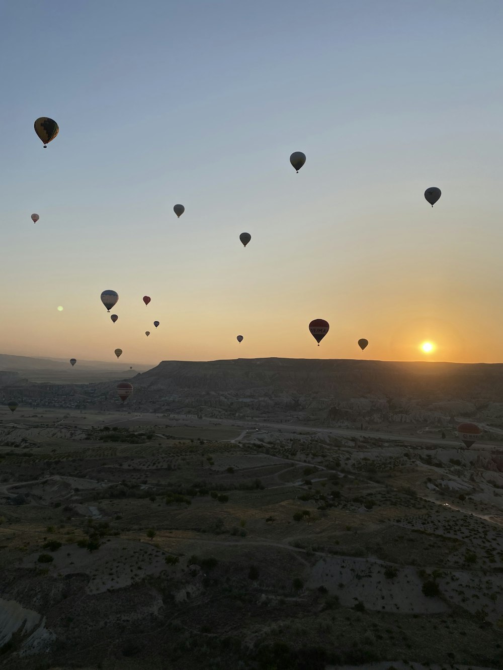 a group of hot air balloons flying in the sky