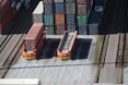 a train yard with cargo containers and train tracks