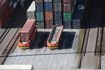 a train yard with cargo containers and train tracks