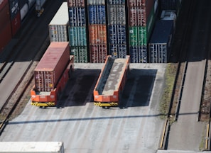 a train yard with cargo containers and train tracks