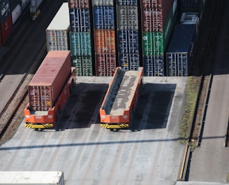 a train yard with cargo containers and train tracks