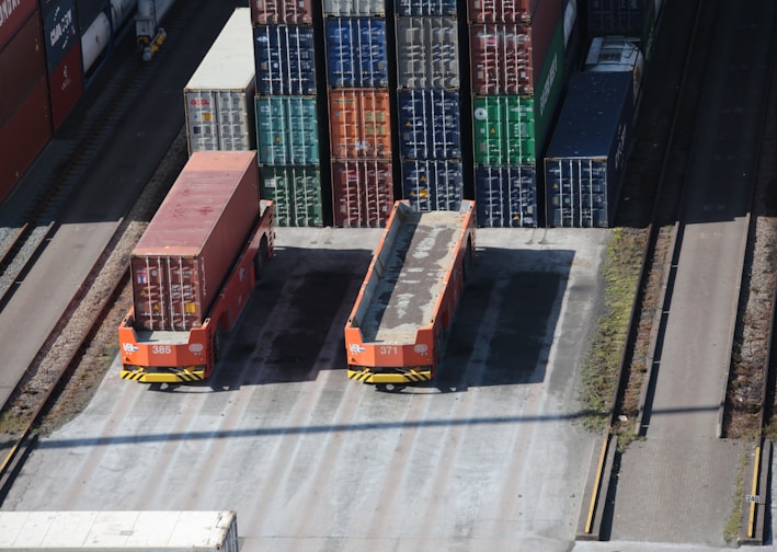 a train yard with cargo containers and train tracks