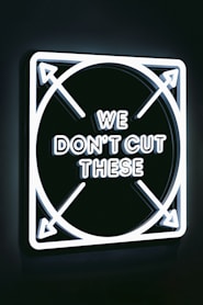 a neon sign that says we don't cut these