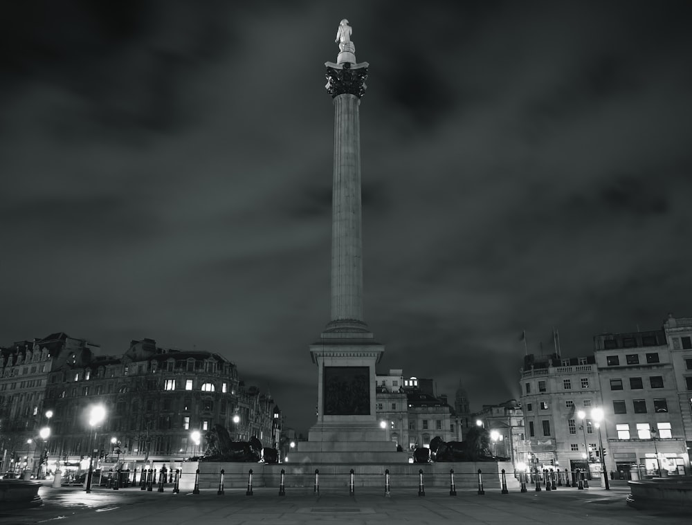 a black and white photo of a monument at night
