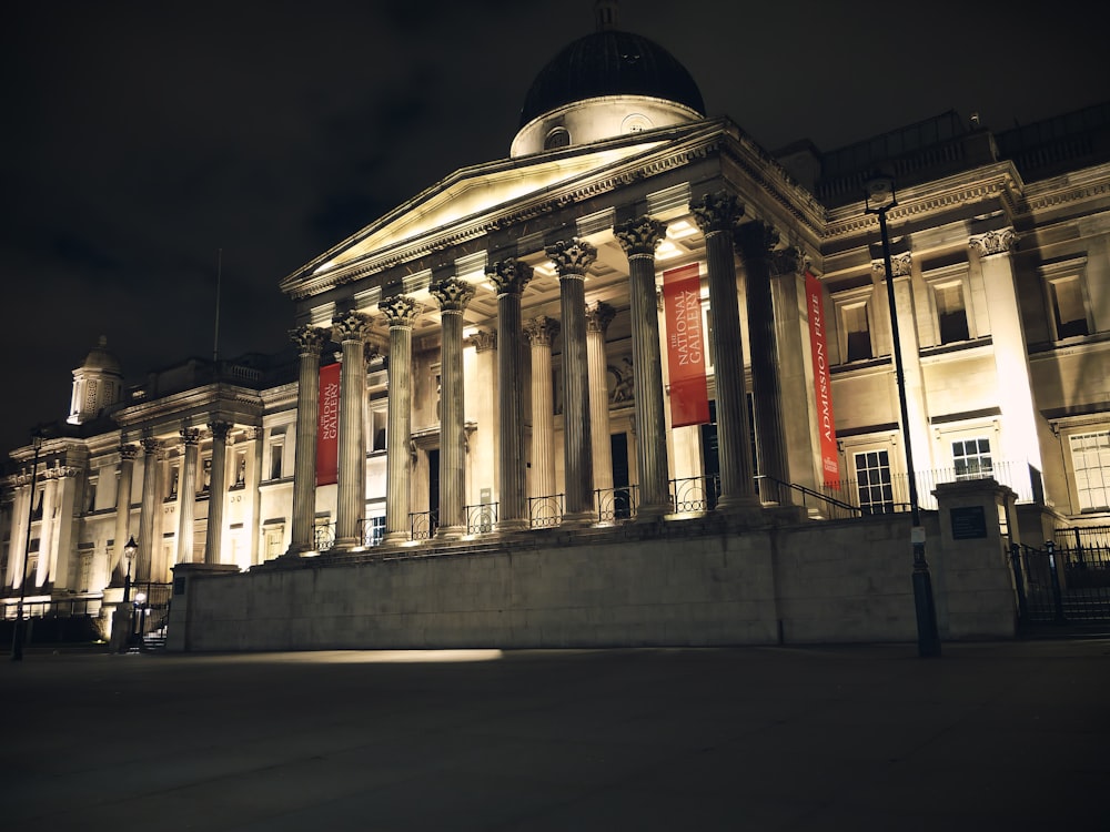 a large building lit up at night with lights on