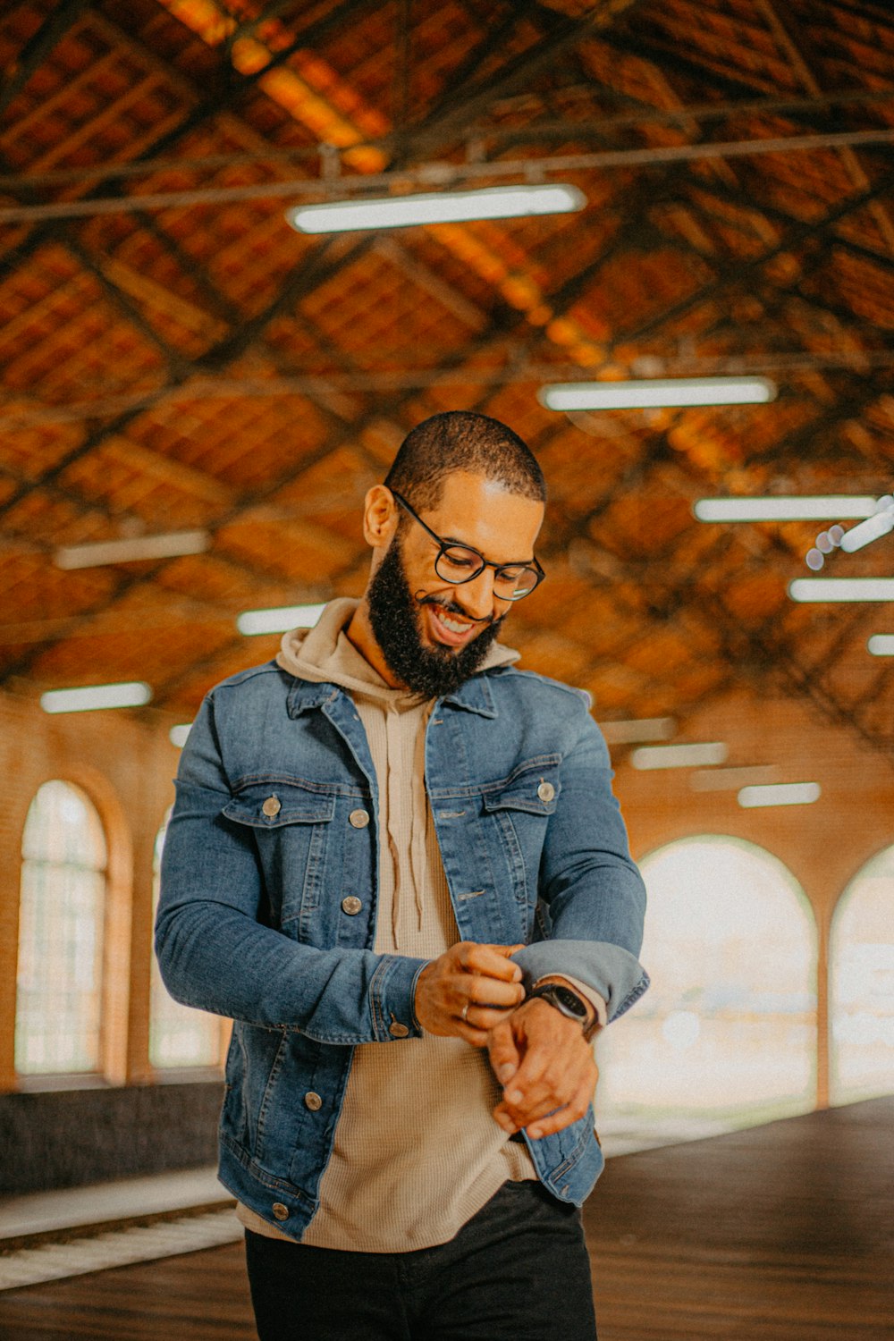 a man standing in a train station looking at his cell phone