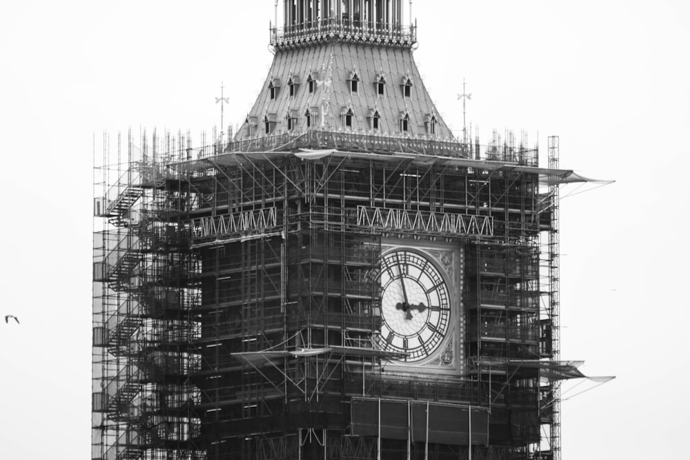 a large clock tower with scaffolding around it