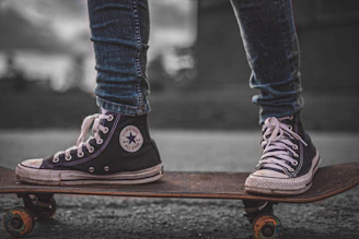 A close-up of a skateboarder’s worn sneakers on a sunlit concrete ramp, embodying urban streetwear style.