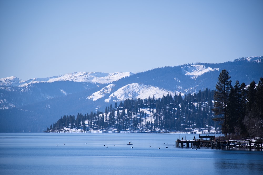 a body of water with mountains in the background