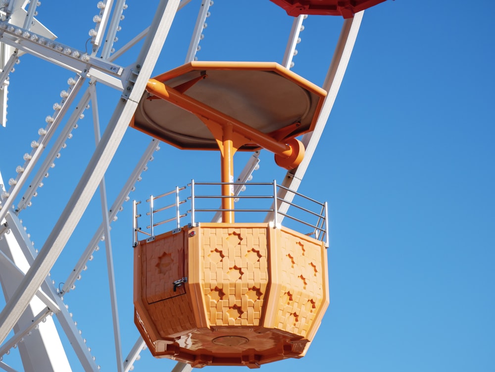 a ferris wheel with a wooden seat on top of it