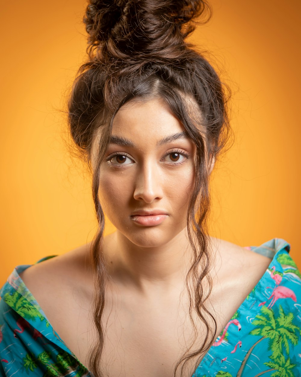 a woman with a messy top knot in her hair