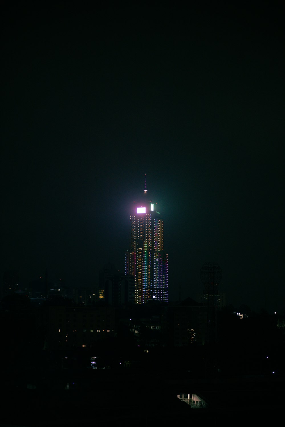 a tall building lit up in the night sky