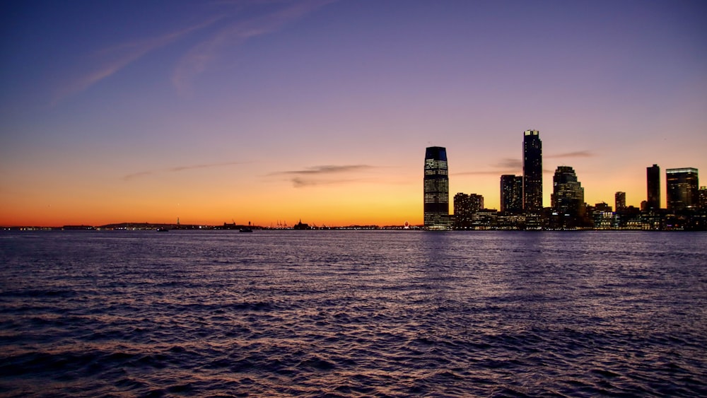 a large body of water with a city in the background